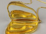gold plated butterfly shaped purse with a mirror on it