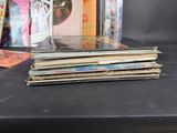 a stack of cds sitting on a table next to a glass case