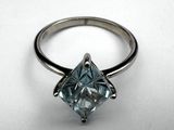 a close up of a diamond ring on a white surface