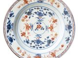 an image of a blue and white plate with flowers on it