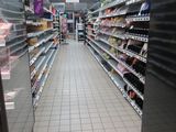 an image of a grocery store aisle with empty shelves
