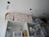 many boxes on top of a shelf in a room