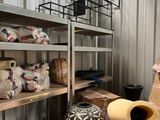 a man standing in a room filled with lots of stuff