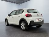 the rear of a white citrole parked in a garage