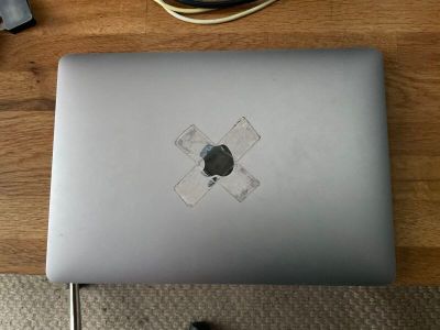 a laptop computer sitting on top of a wooden table