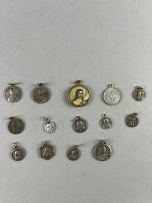 a group of silver and gold medals and a gold medal on a white surface