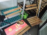 a small table with a bowl of food on it next to a set of stairs