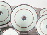 many plates and bowls that are sitting on a table