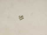 an old picture of a white plate with a crown on it