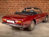 an image of a red convertible car parked in a garage