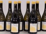 six bottles of wine are lined up on a table