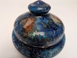 a picture of a blue stone covered box on a white surface