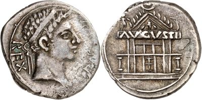 a silver coin with an image of a woman holding a cage