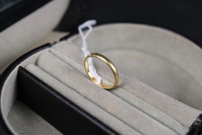 a wedding ring sitting in a ring case on a table