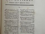 an old book with black writing on it sitting on top of a table