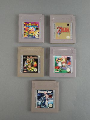 four nintendo game cartridges sitting on top of each other on a table