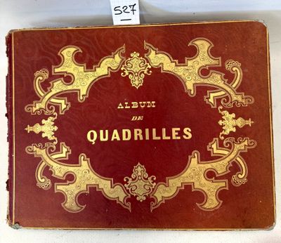 an old red and gold book with a gold border on top of it