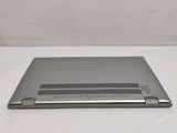 a silver laptop computer sitting on a white surface