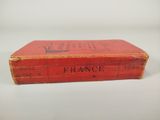 an old red book with a black writing on it
