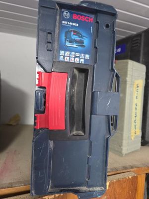 a blue box with a red handle on a shelf