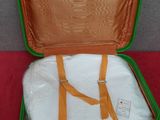 a green suitcase with a white shirt inside of it