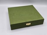 a green box with a gold handle on a white background