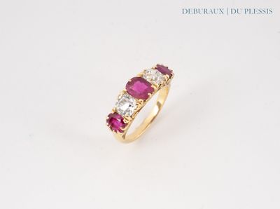 a close up of a ring with three stones on a white surface