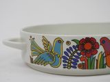 a white bowl with colorful birds and flowers on it