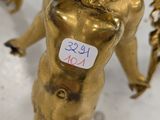 an image of a gold statue of a woman with a bird on her shoulder