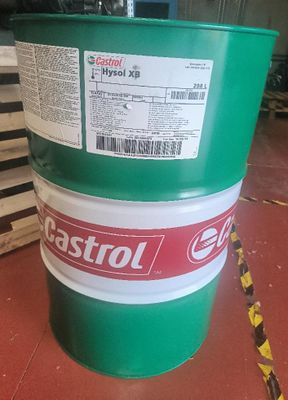 a green barrel with a label on it sitting on a red floor