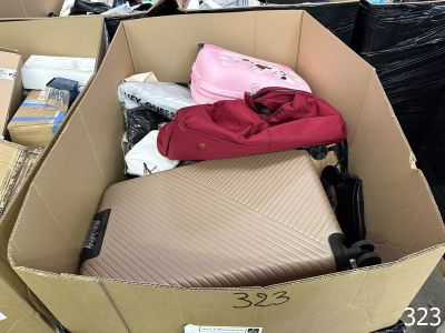 a cardboard box filled with luggage and other items