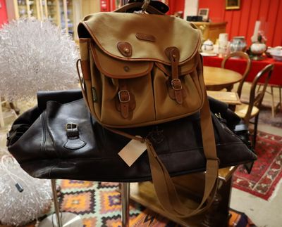 a brown and black bag sitting on top of a chair