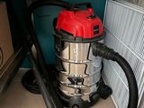 a vacuum that is sitting on the floor next to a radiator