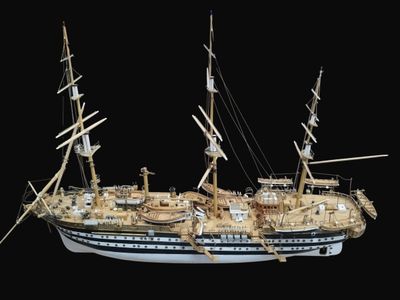 a model of a ship on display on a black background