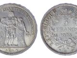 a silver coin with the image of a woman and a man on it