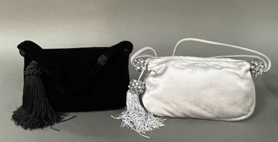 black and white purses with tassels sitting on a table
