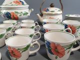 many cups and saucers that are sitting on a table