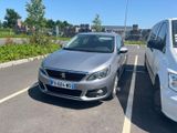 two cars parked in a parking lot next to each other