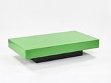 a green coffee table with a black base on a white background