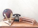 a wooden table with a telephone and other items on it