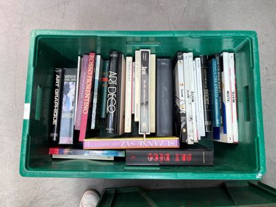 a green box filled with lots of books on the floor