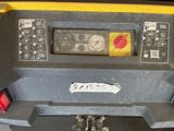 a close up of a yellow and black machine on a table