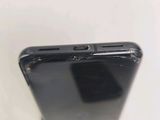 a close up of a cell phone with a broken screen