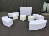 a lot of white furniture in the middle of a parking lot
