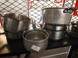 several pots and pans are on a counter in a kitchen