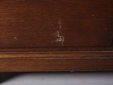 a close up view of a wooden dresser with a drawer underneath it