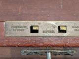 a close up of a metal switch on a wooden table