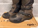 two pairs of boots are sitting on a box in front of a brick wall