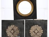 two black and gold boxes with a mirror on top of them