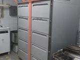 a kitchen with many drawers and a stove in it